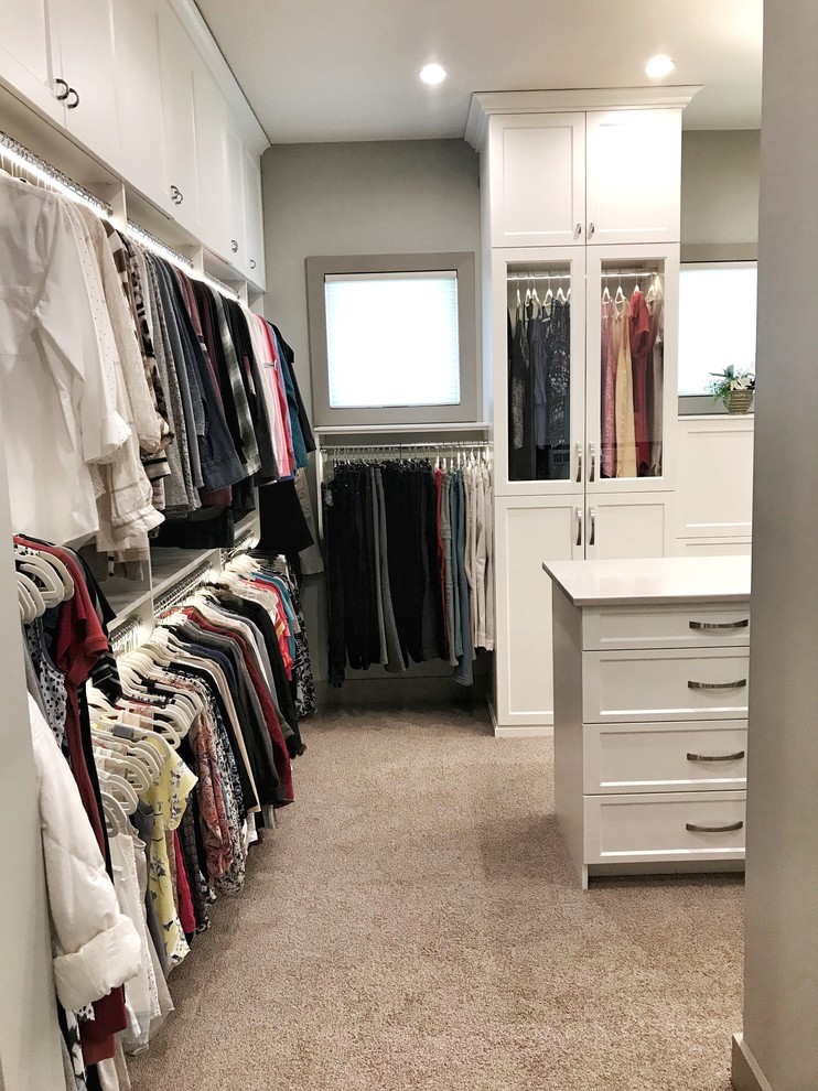Inspiration for a large transitional carpeted and beige floor walk-in closet remodel in Other with flat-panel cabinets and white cabinets