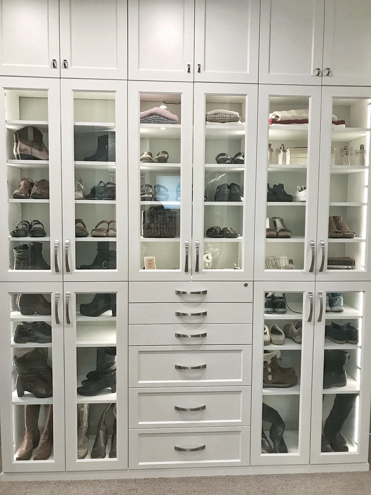 Design ideas for a large traditional walk-in wardrobe in Other with flat-panel cabinets, white cabinets, carpet and beige floors.