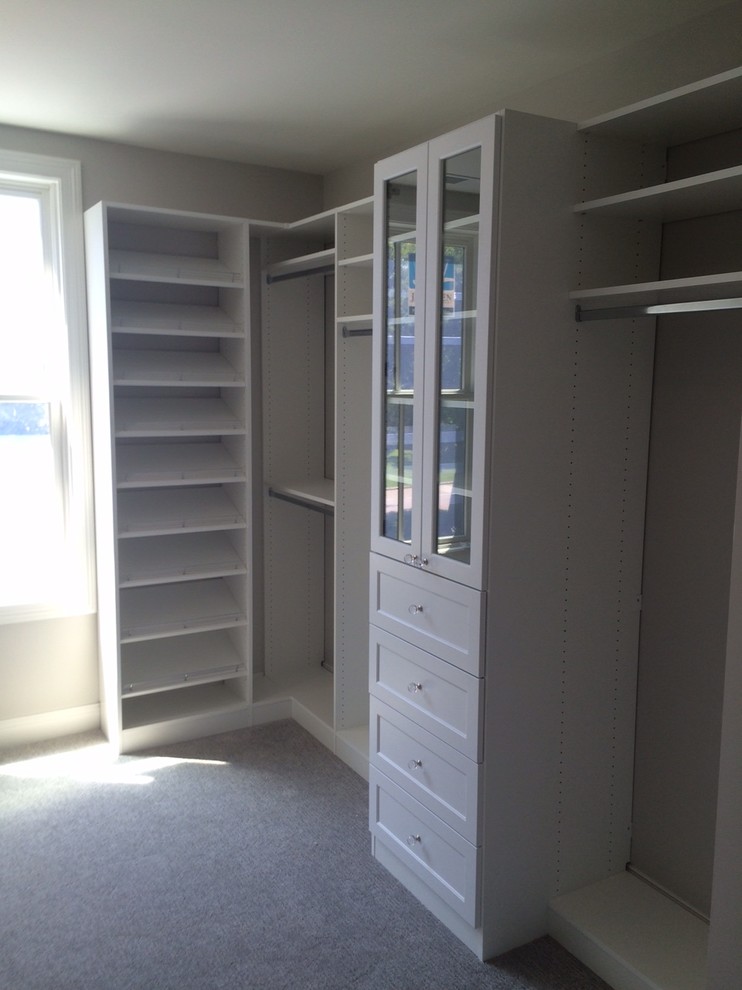 Photo of a large traditional gender neutral walk-in wardrobe in Chicago with shaker cabinets and white cabinets.