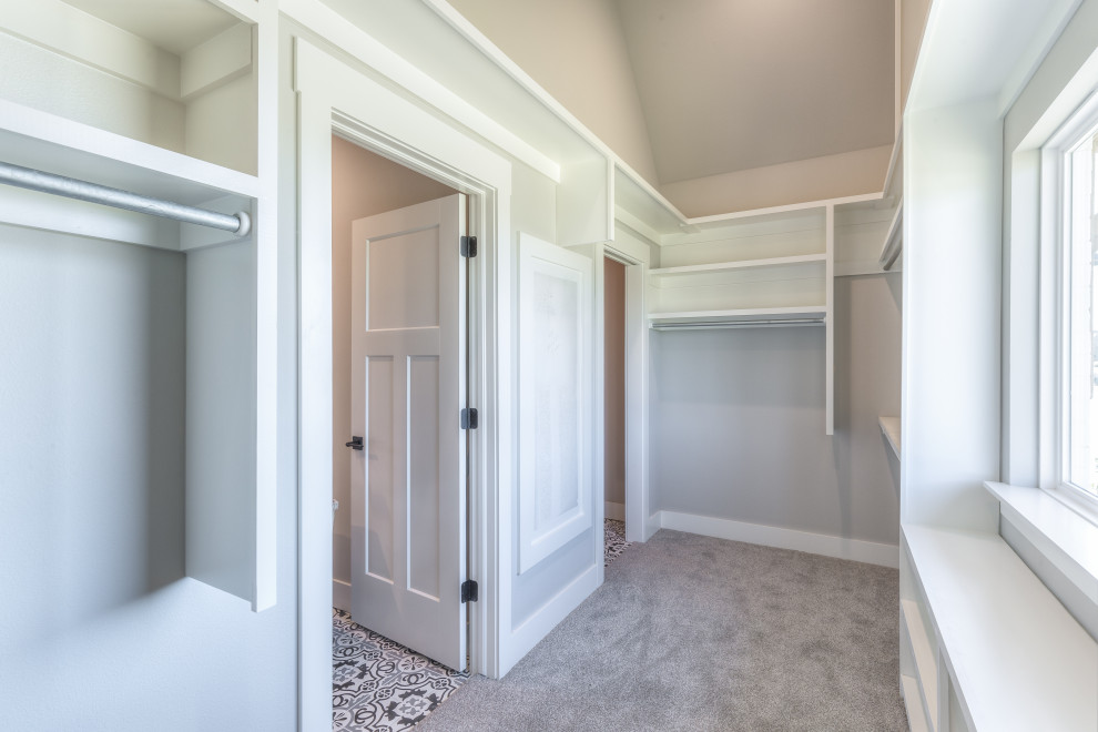 Design ideas for a medium sized contemporary gender neutral walk-in wardrobe in Other with open cabinets, white cabinets, carpet and grey floors.