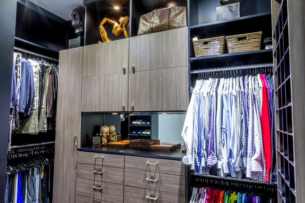 Design ideas for a medium sized modern gender neutral walk-in wardrobe in Houston with flat-panel cabinets, carpet and brown cabinets.