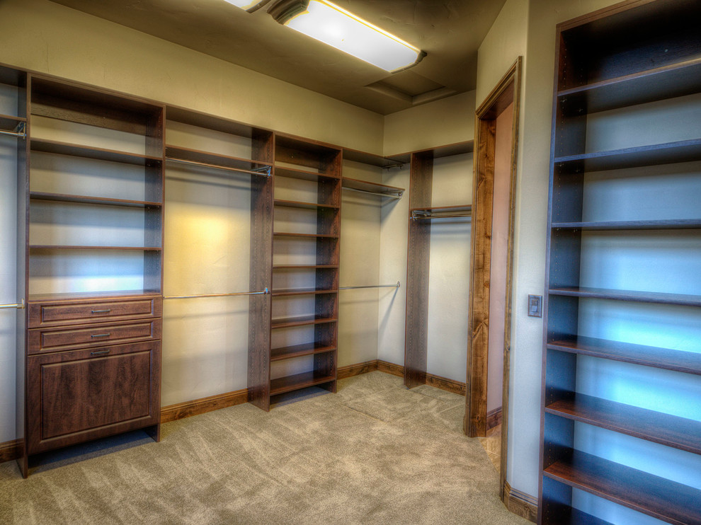 Design ideas for a large contemporary wardrobe in Other with raised-panel cabinets, dark wood cabinets and carpet.