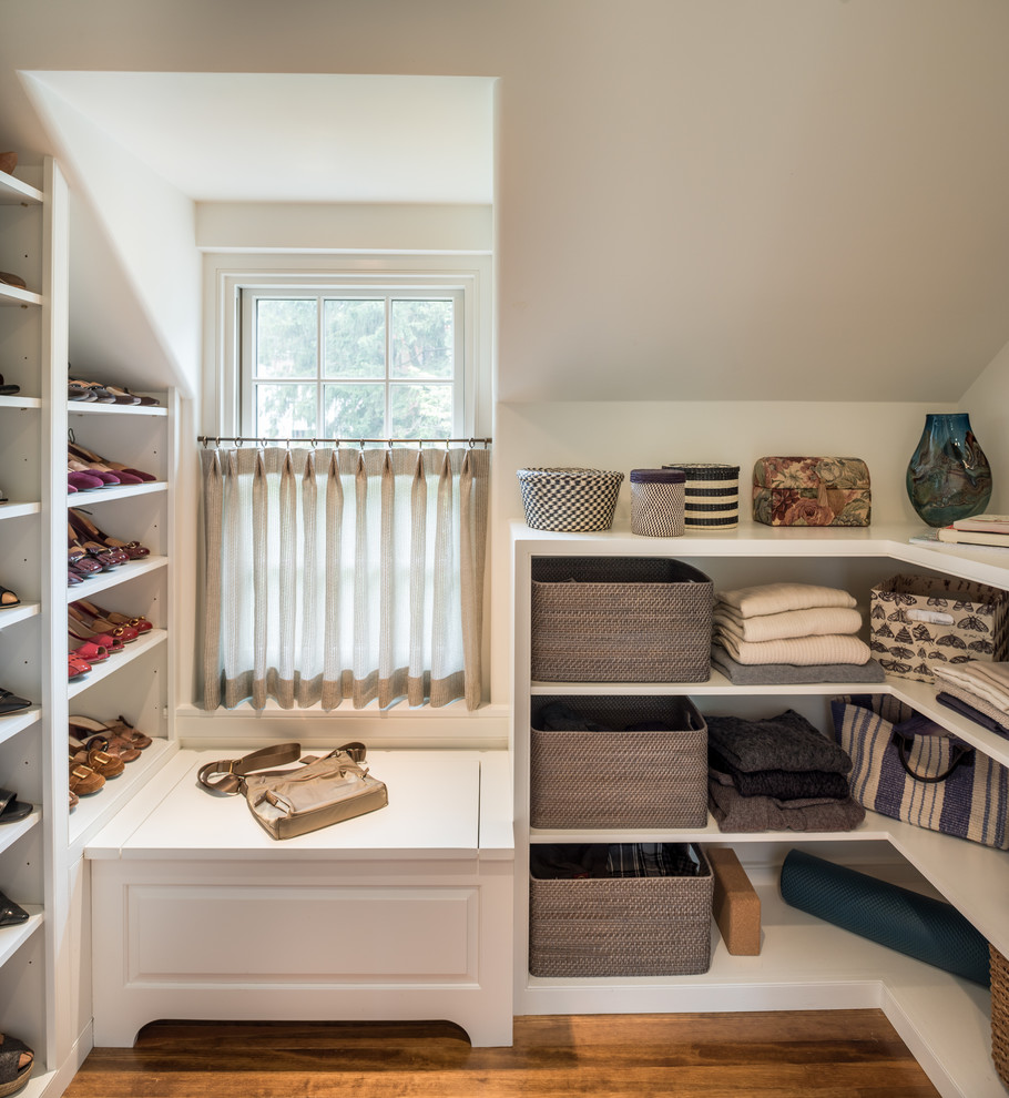This is an example of a classic walk-in wardrobe in Philadelphia with open cabinets, white cabinets, medium hardwood flooring and brown floors.