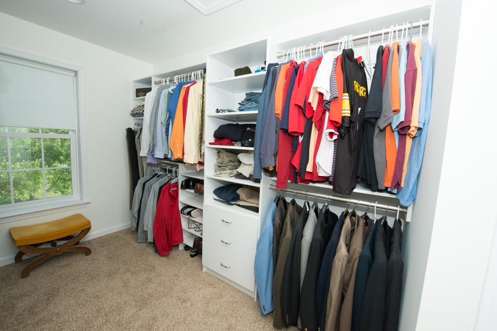 Inspiration for a medium sized traditional gender neutral walk-in wardrobe in Philadelphia with flat-panel cabinets, white cabinets and carpet.