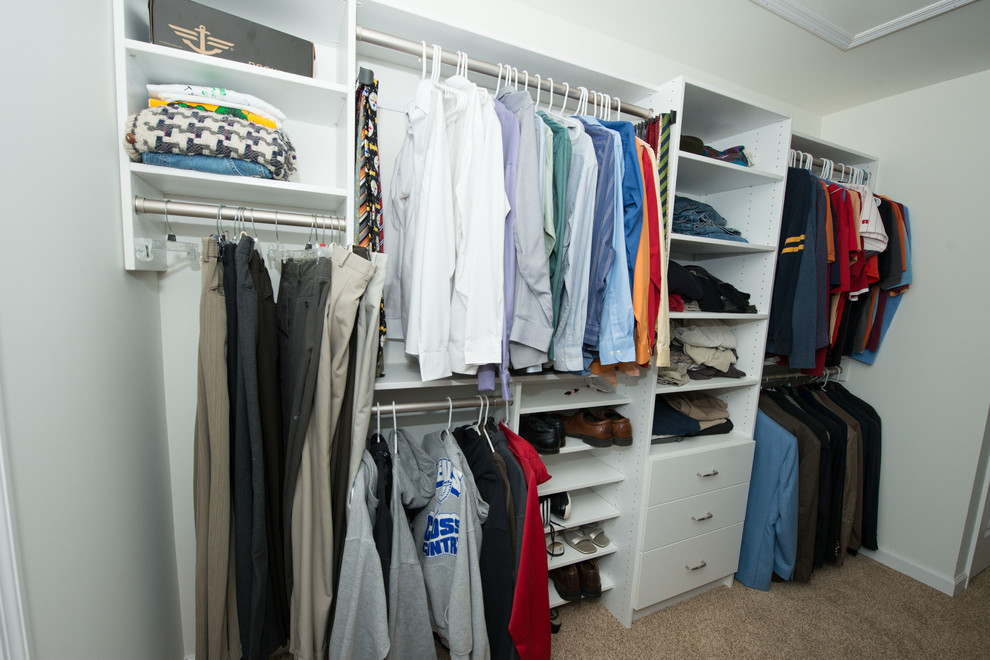 Example of a mid-sized classic gender-neutral carpeted walk-in closet design in Philadelphia with flat-panel cabinets and white cabinets