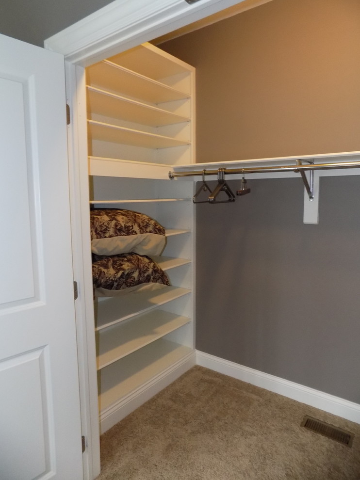 Inspiration for a large contemporary gender-neutral carpeted walk-in closet remodel in Columbus with open cabinets and white cabinets