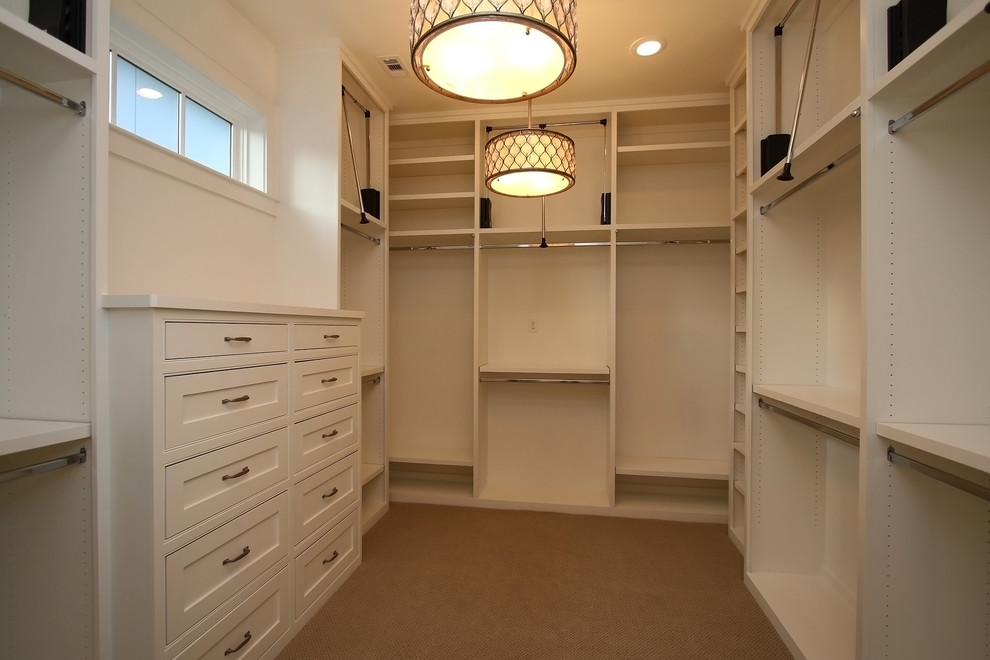 Walk-in closet - mid-sized traditional gender-neutral walk-in closet idea in Houston with beaded inset cabinets