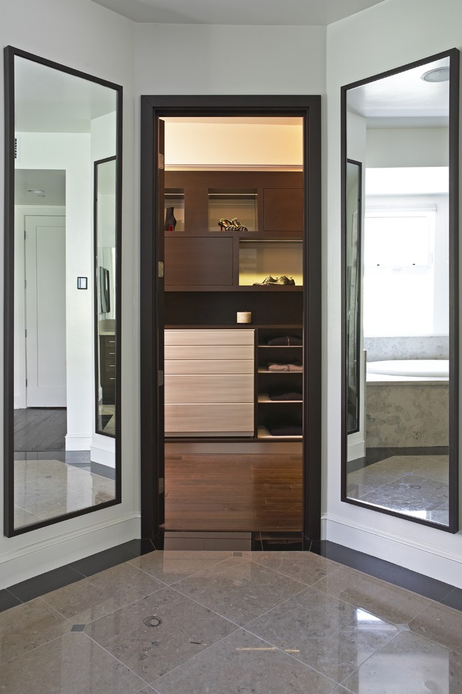 This is an example of a contemporary walk-in wardrobe in Los Angeles.