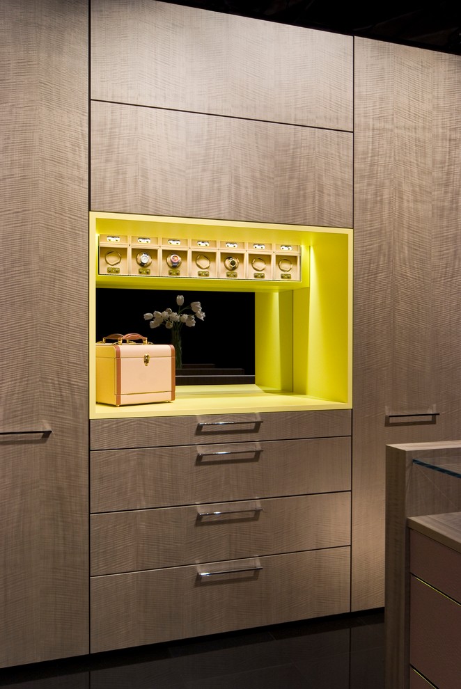 Réalisation d'un dressing room minimaliste en bois brun de taille moyenne et neutre avec un placard à porte plane.