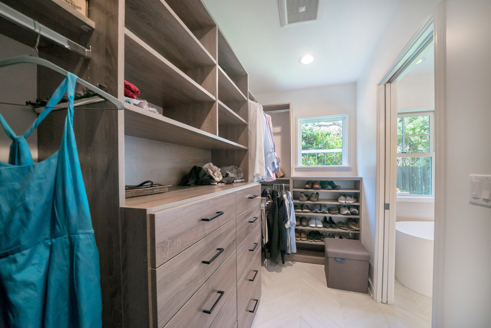 Photo of a medium sized traditional gender neutral walk-in wardrobe in Los Angeles with flat-panel cabinets, dark wood cabinets, porcelain flooring and grey floors.