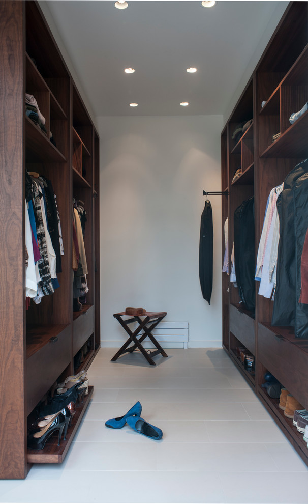 Large trendy gender-neutral porcelain tile walk-in closet photo in DC Metro with flat-panel cabinets and dark wood cabinets