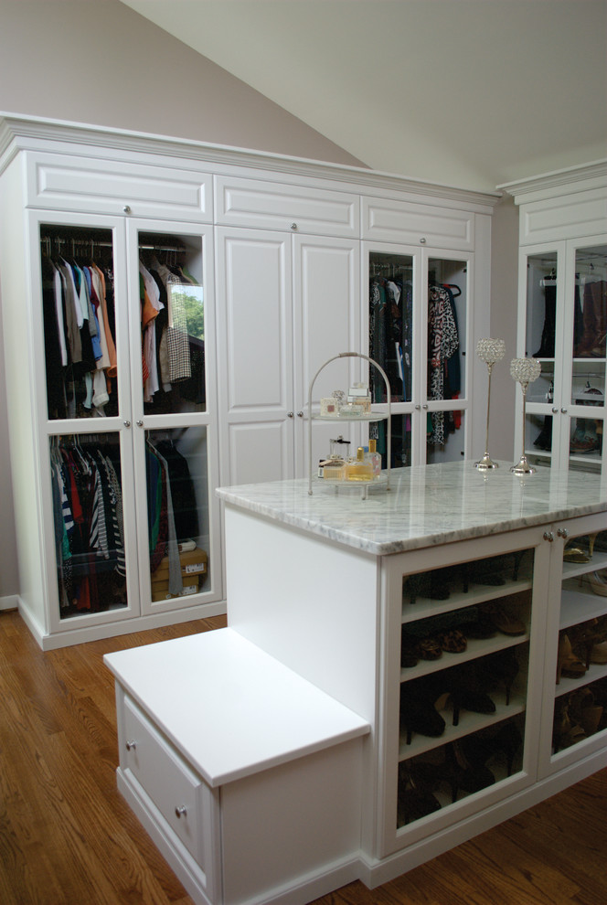 Large elegant women's medium tone wood floor dressing room photo in DC Metro with white cabinets and glass-front cabinets