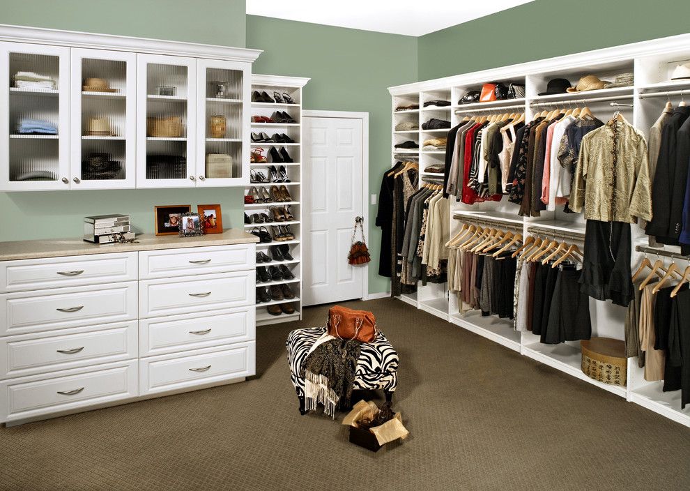 Example of a mid-sized classic gender-neutral carpeted and brown floor walk-in closet design in Los Angeles with raised-panel cabinets and white cabinets