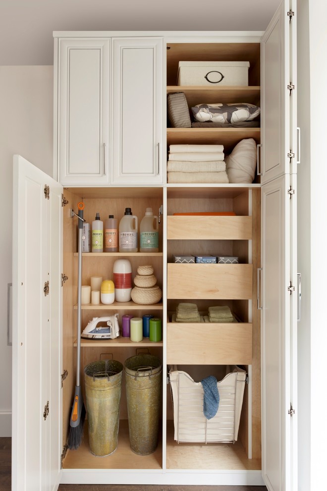 Inspiration for a medium sized modern gender neutral standard wardrobe in New York with white cabinets, dark hardwood flooring and raised-panel cabinets.