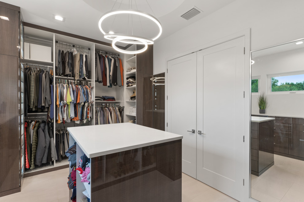 Photo of a medium sized contemporary gender neutral walk-in wardrobe in Tampa with flat-panel cabinets, dark wood cabinets, light hardwood flooring and beige floors.