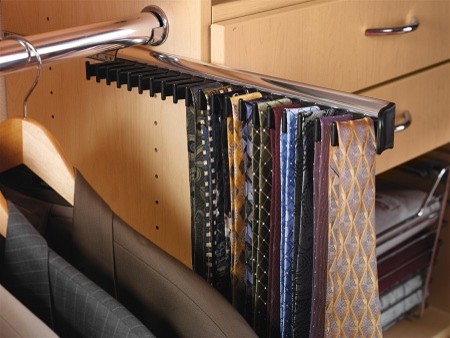 Example of a classic men's walk-in closet design in Orange County with flat-panel cabinets and light wood cabinets