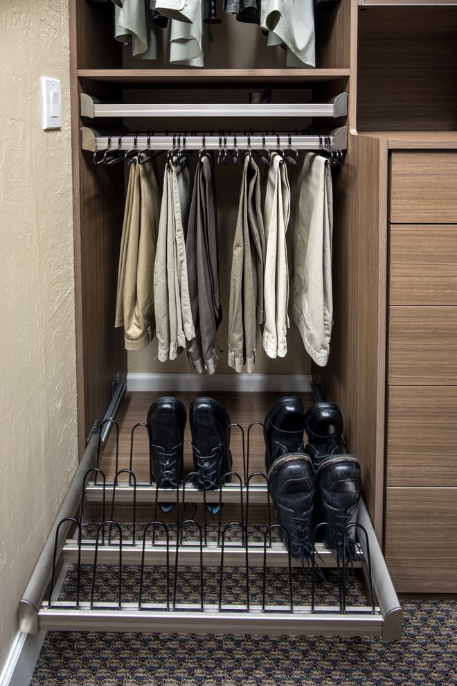 Reach-in closet - small contemporary gender-neutral carpeted reach-in closet idea in San Francisco with glass-front cabinets and medium tone wood cabinets