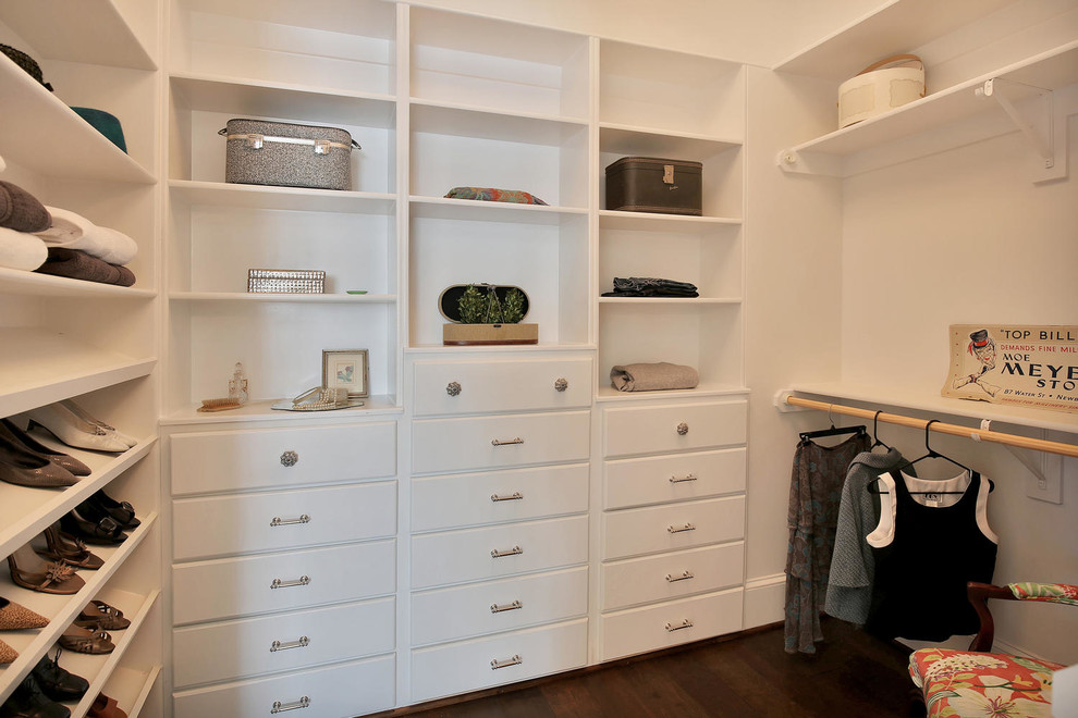 Example of a mid-sized arts and crafts dark wood floor walk-in closet design in Richmond with flat-panel cabinets and white cabinets
