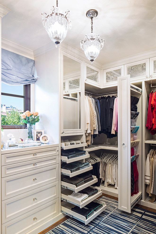 Inspiration for a timeless closet remodel in Los Angeles with white cabinets