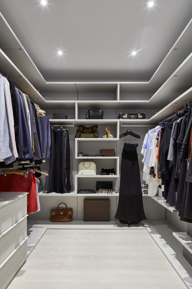 Trendy gender-neutral light wood floor and beige floor walk-in closet photo in Toronto with open cabinets
