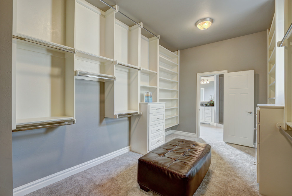 Inspiration for a mid-sized transitional gender-neutral carpeted and beige floor dressing room remodel in Oklahoma City with raised-panel cabinets and white cabinets
