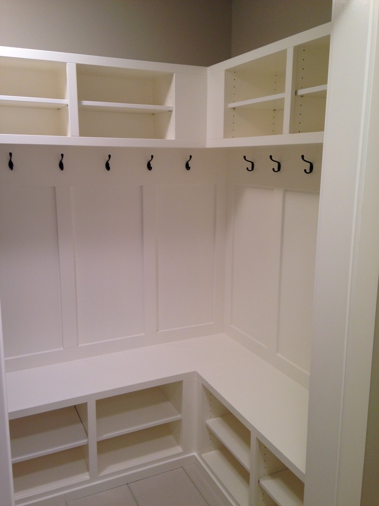 Large elegant ceramic tile walk-in closet photo in Calgary with open cabinets and white cabinets