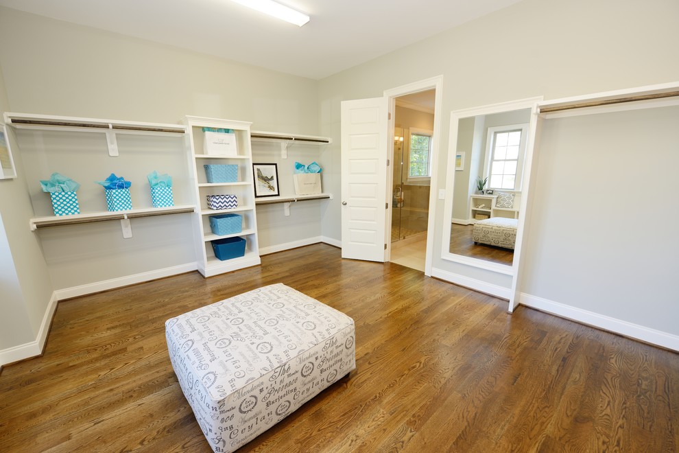 Inspiration for a traditional gender neutral walk-in wardrobe in Raleigh with medium hardwood flooring.