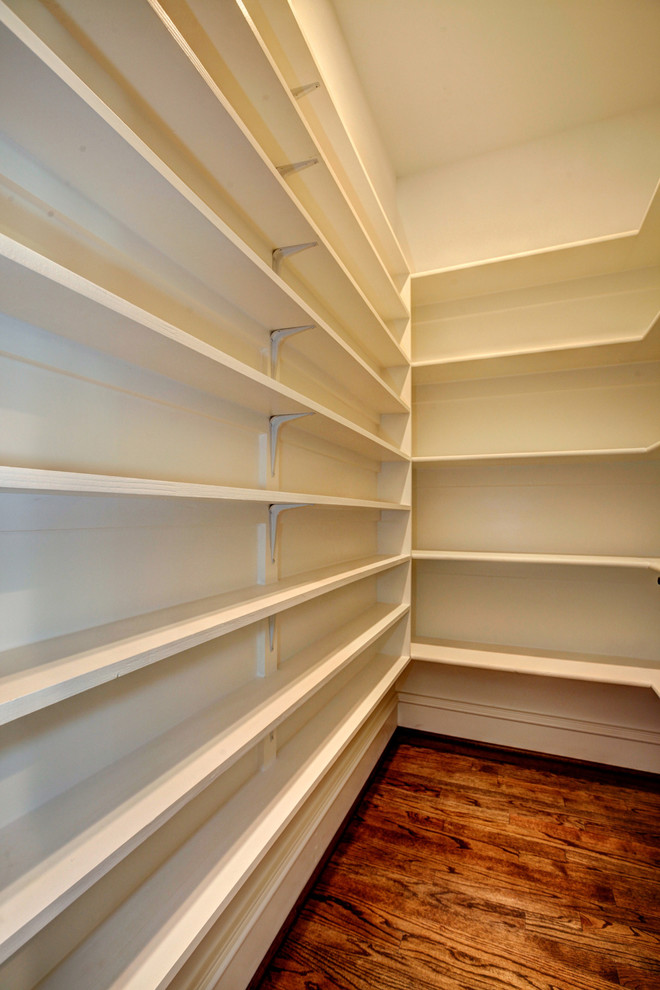 Walk-in closet - mid-sized craftsman gender-neutral medium tone wood floor walk-in closet idea in DC Metro with open cabinets and white cabinets