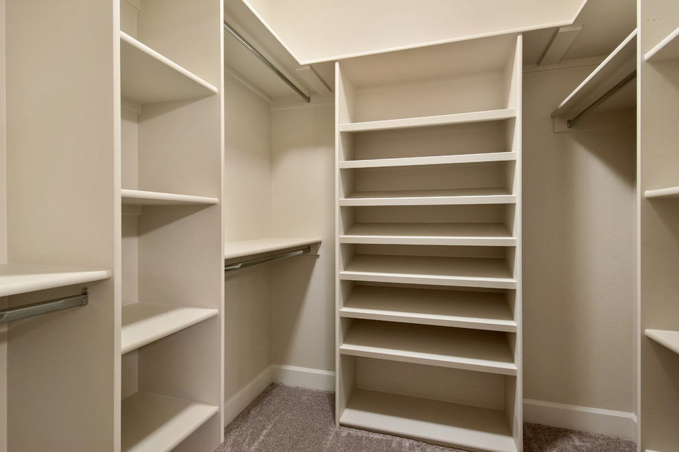 Design ideas for a medium sized classic gender neutral walk-in wardrobe in Boise with carpet, open cabinets and beige cabinets.