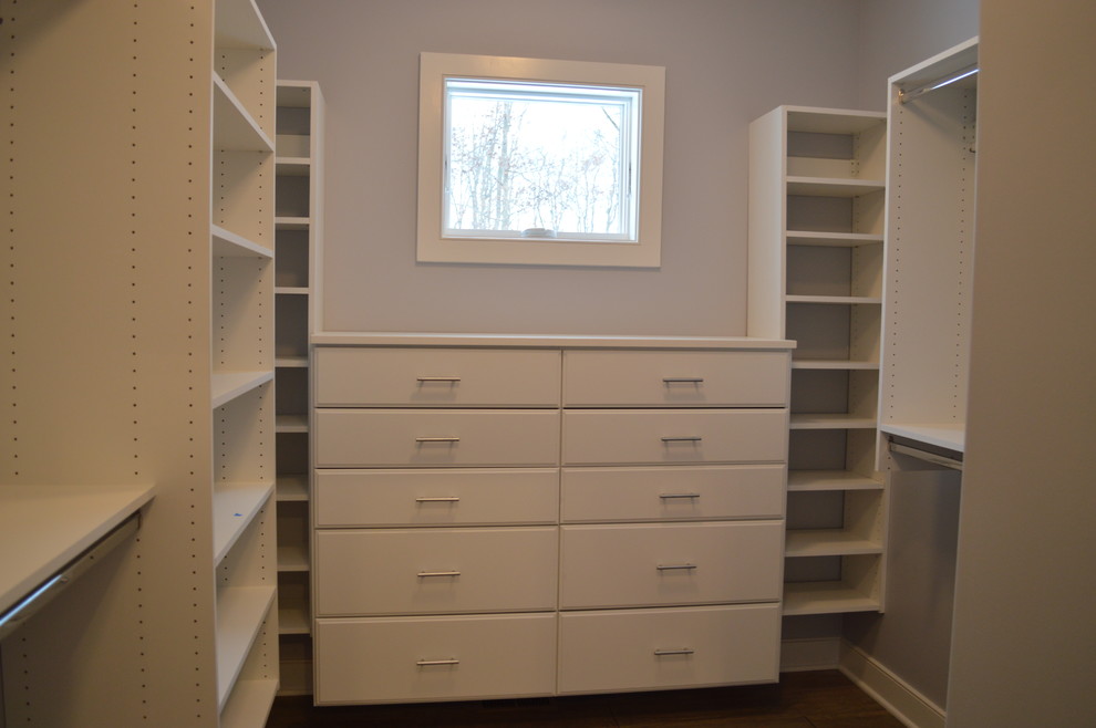 Walk-in closet - mid-sized craftsman gender-neutral carpeted and beige floor walk-in closet idea in Other with flat-panel cabinets and white cabinets