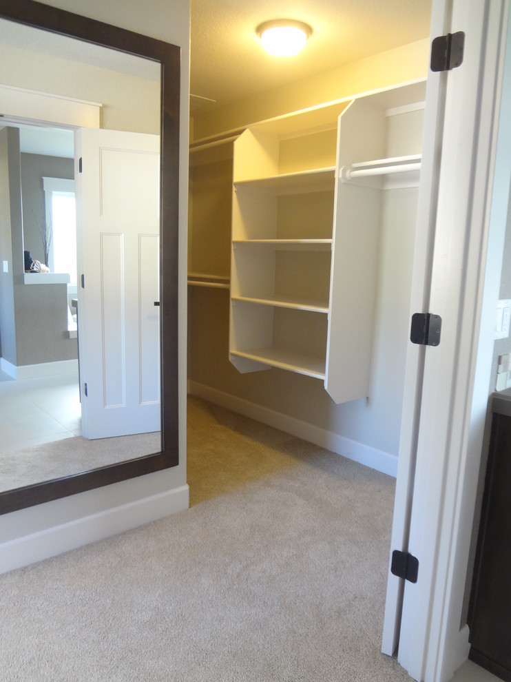 Photo of a medium sized classic wardrobe in Portland with shaker cabinets, dark wood cabinets and carpet.
