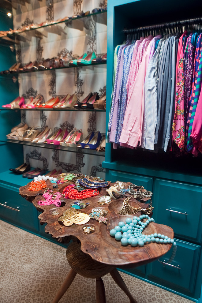 Small bohemian dressing room for women in Charleston with raised-panel cabinets, blue cabinets and carpet.