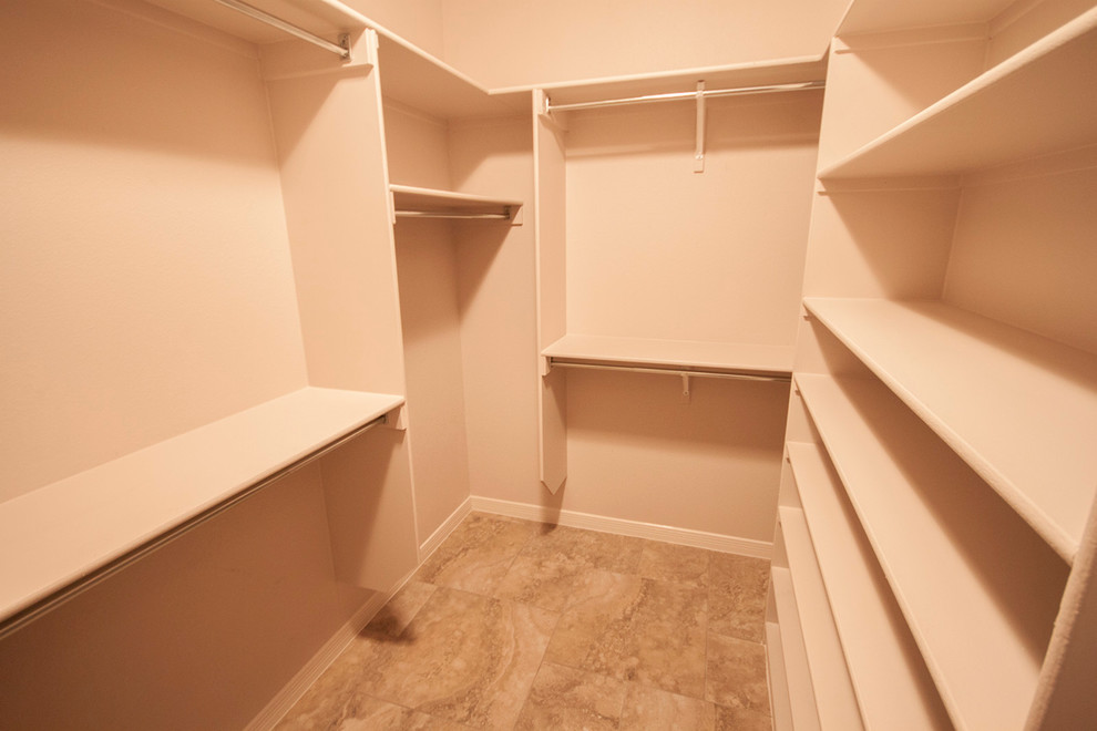 Walk-in closet - mid-sized traditional gender-neutral ceramic tile walk-in closet idea in Austin with open cabinets and white cabinets