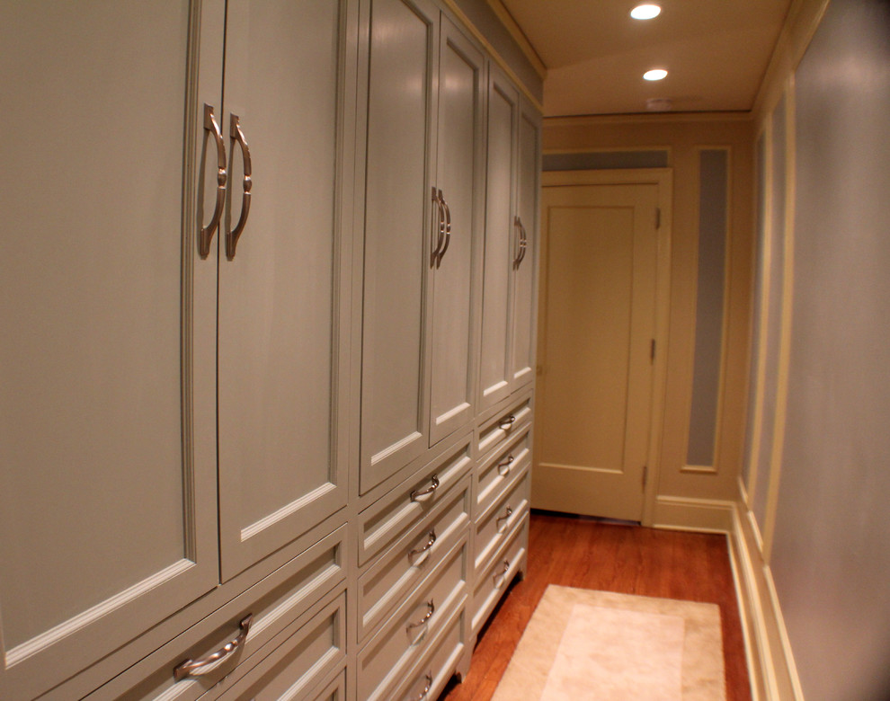 This is an example of a small classic gender neutral dressing room in Omaha with recessed-panel cabinets, grey cabinets, medium hardwood flooring and brown floors.