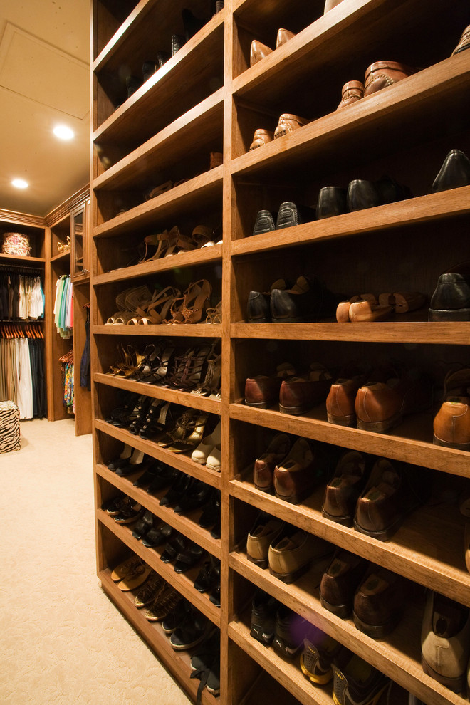 Inspiration for a large timeless gender-neutral carpeted walk-in closet remodel in Dallas with raised-panel cabinets and medium tone wood cabinets