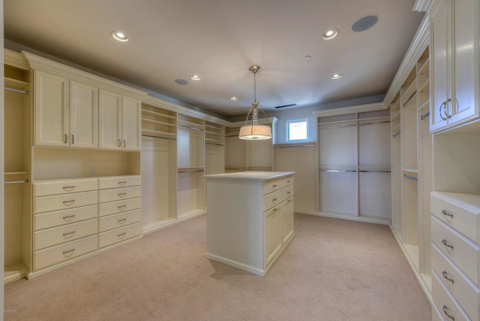 Walk-in closet - huge transitional carpeted walk-in closet idea in Phoenix with white cabinets