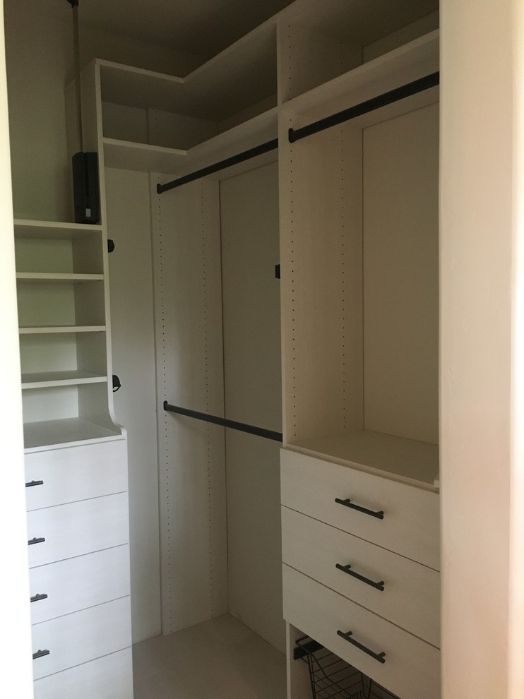 Inspiration for a medium sized classic gender neutral walk-in wardrobe in Denver with flat-panel cabinets, white cabinets, carpet and grey floors.
