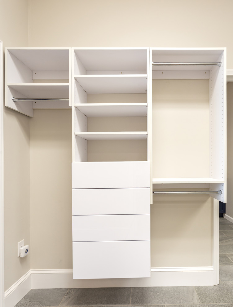 Medium sized traditional gender neutral walk-in wardrobe in Other with open cabinets, white cabinets, porcelain flooring and grey floors.