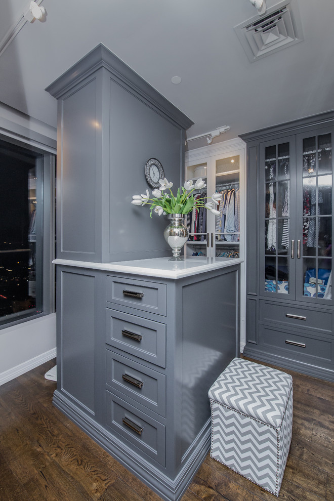 Mid-sized transitional gender-neutral medium tone wood floor dressing room photo in Austin with recessed-panel cabinets and gray cabinets