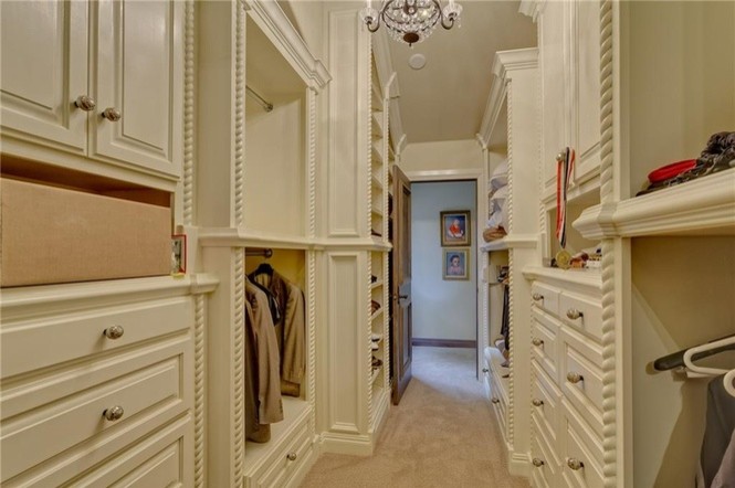 Foto de armario vestidor de mujer clásico renovado grande con armarios con paneles con relieve, puertas de armario beige y moqueta