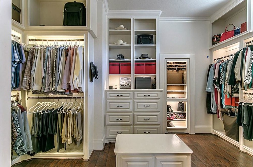 Dressing room - large mediterranean gender-neutral dark wood floor dressing room idea in Houston with flat-panel cabinets and white cabinets