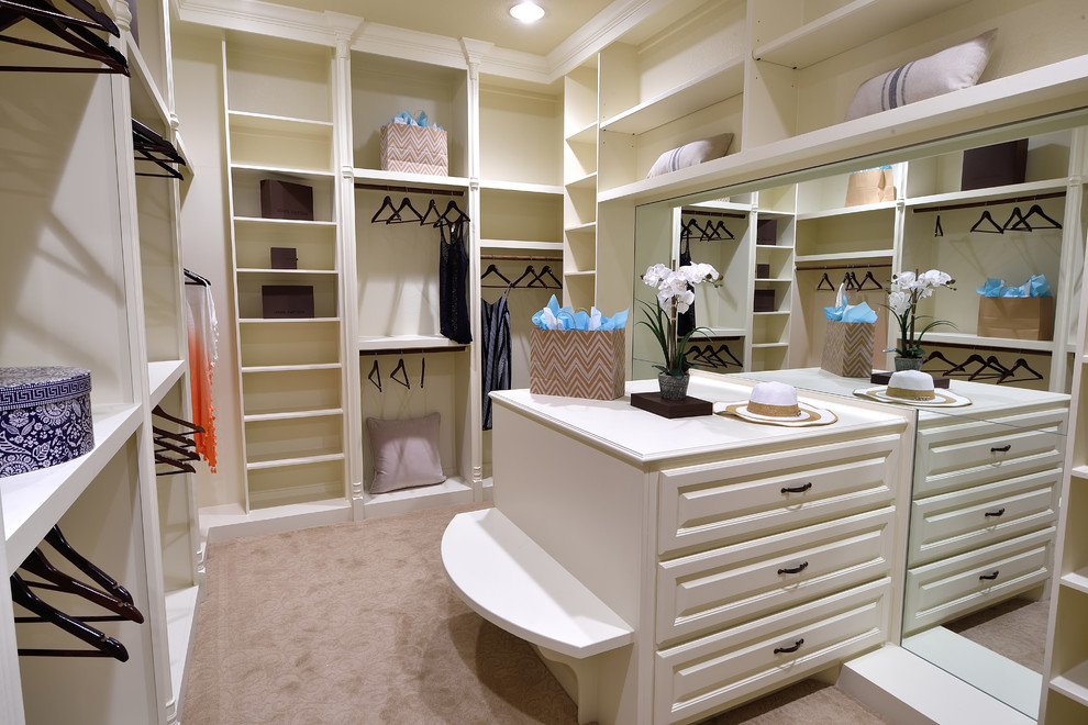 Dressing room - large mediterranean women's carpeted and beige floor dressing room idea in Houston with raised-panel cabinets and white cabinets