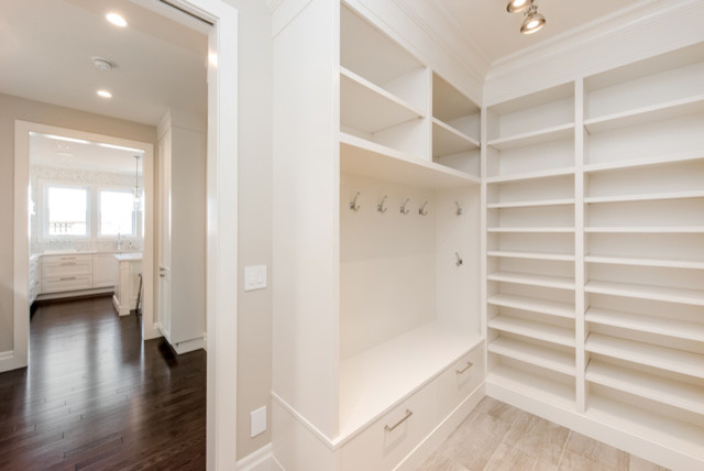 Photo of a medium sized traditional walk-in wardrobe in Other with white cabinets.
