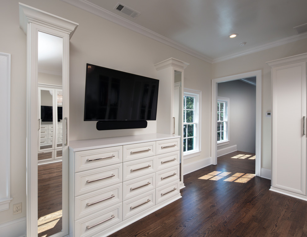 Photo of an expansive traditional dressing room for women in Atlanta with white cabinets, medium hardwood flooring and brown floors.