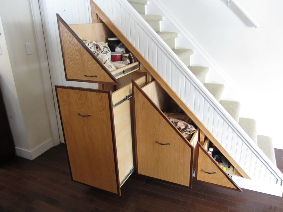 This is an example of a contemporary staircase in Toronto with under stair storage.