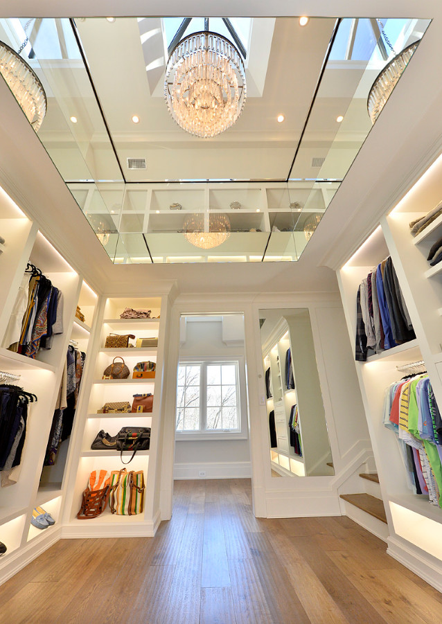 Walk-in closet - huge transitional gender-neutral medium tone wood floor walk-in closet idea in New York with open cabinets and white cabinets