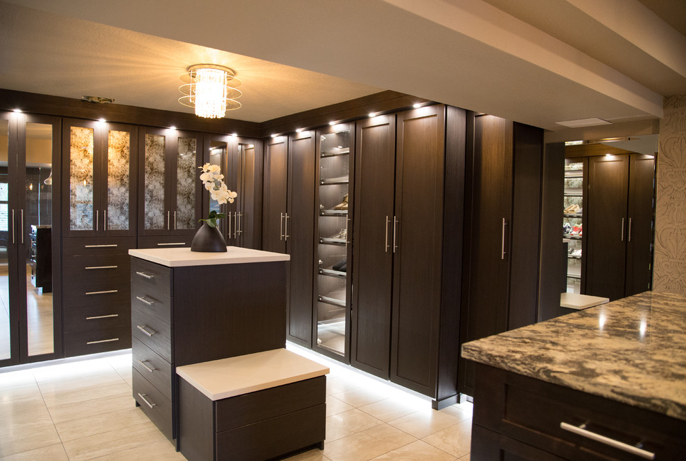 Inspiration for a large contemporary gender-neutral porcelain tile walk-in closet remodel in Seattle with shaker cabinets and dark wood cabinets