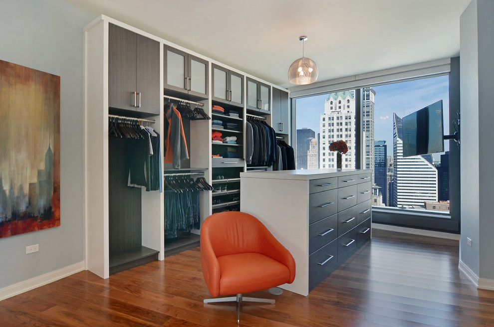 Contemporary dressing room for men in Chicago with flat-panel cabinets, dark wood cabinets and medium hardwood flooring.