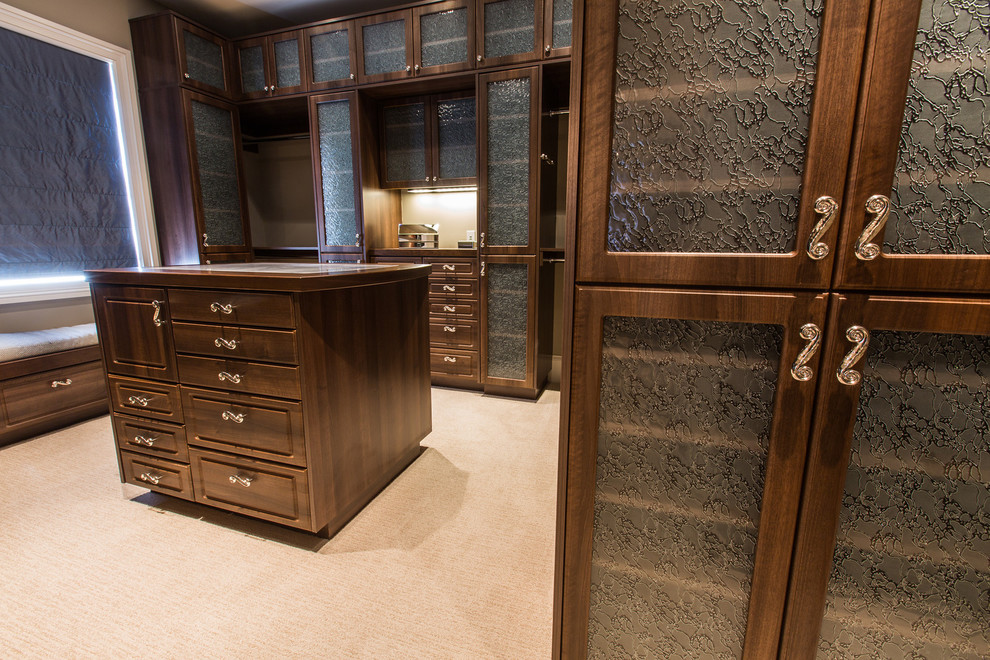 Walk-in closet - huge traditional women's carpeted walk-in closet idea in San Diego with raised-panel cabinets and dark wood cabinets