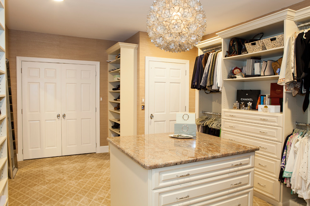 Inspiration for a large timeless women's carpeted dressing room remodel in Philadelphia with raised-panel cabinets and white cabinets